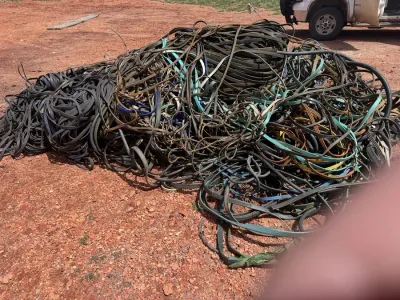Pile of scrap cable in a dirt lot