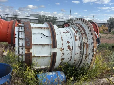 Large rusted industrial motor housing awaiting scrap processing